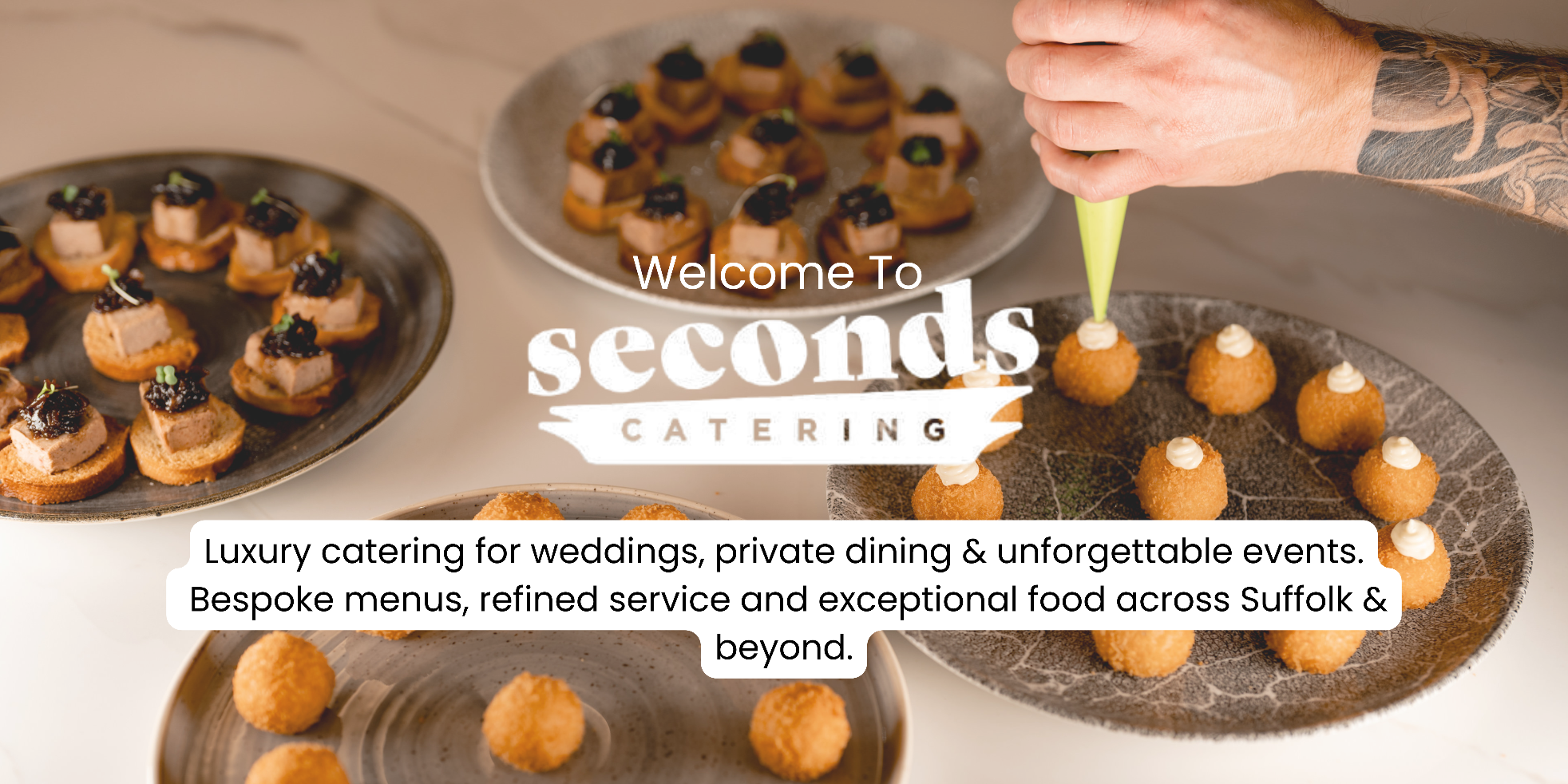 Chefs hand piping cheese onto arancini balls